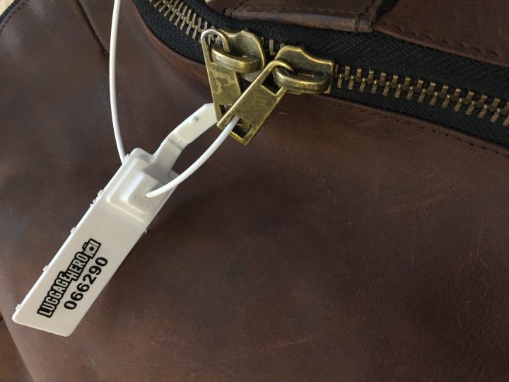 LuggageHero security tag applied through the zippers